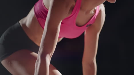 slow-motion-female-runner-at-the-start-close-up-in-the-dark-at-the-stadium-professional-runner-athletic